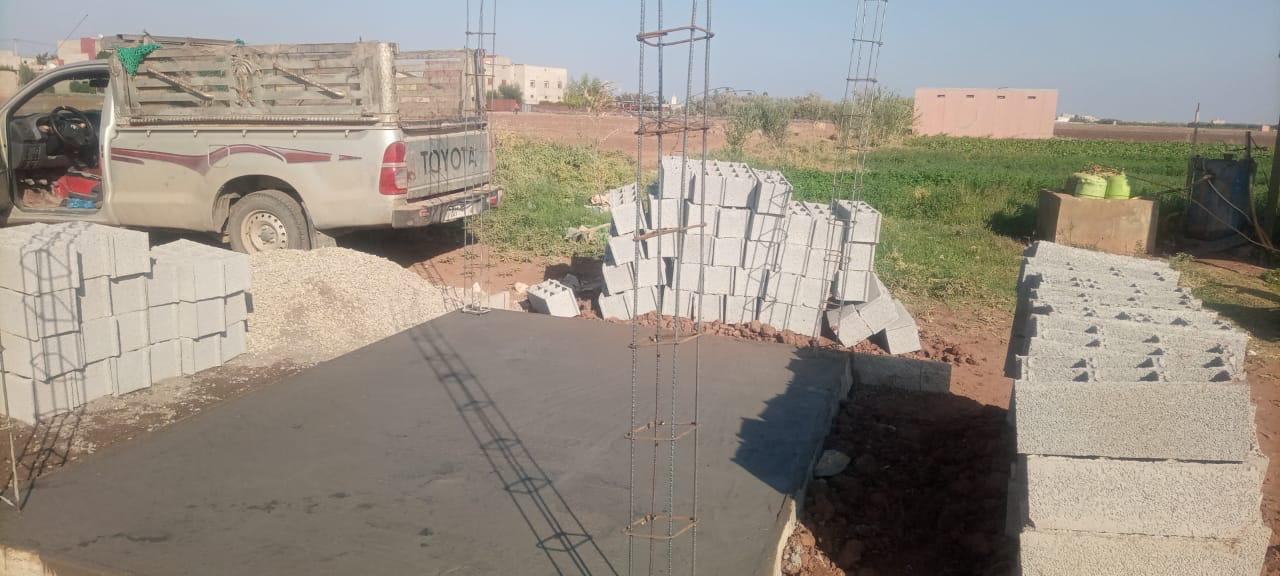 Construction site with concrete foundation and materials