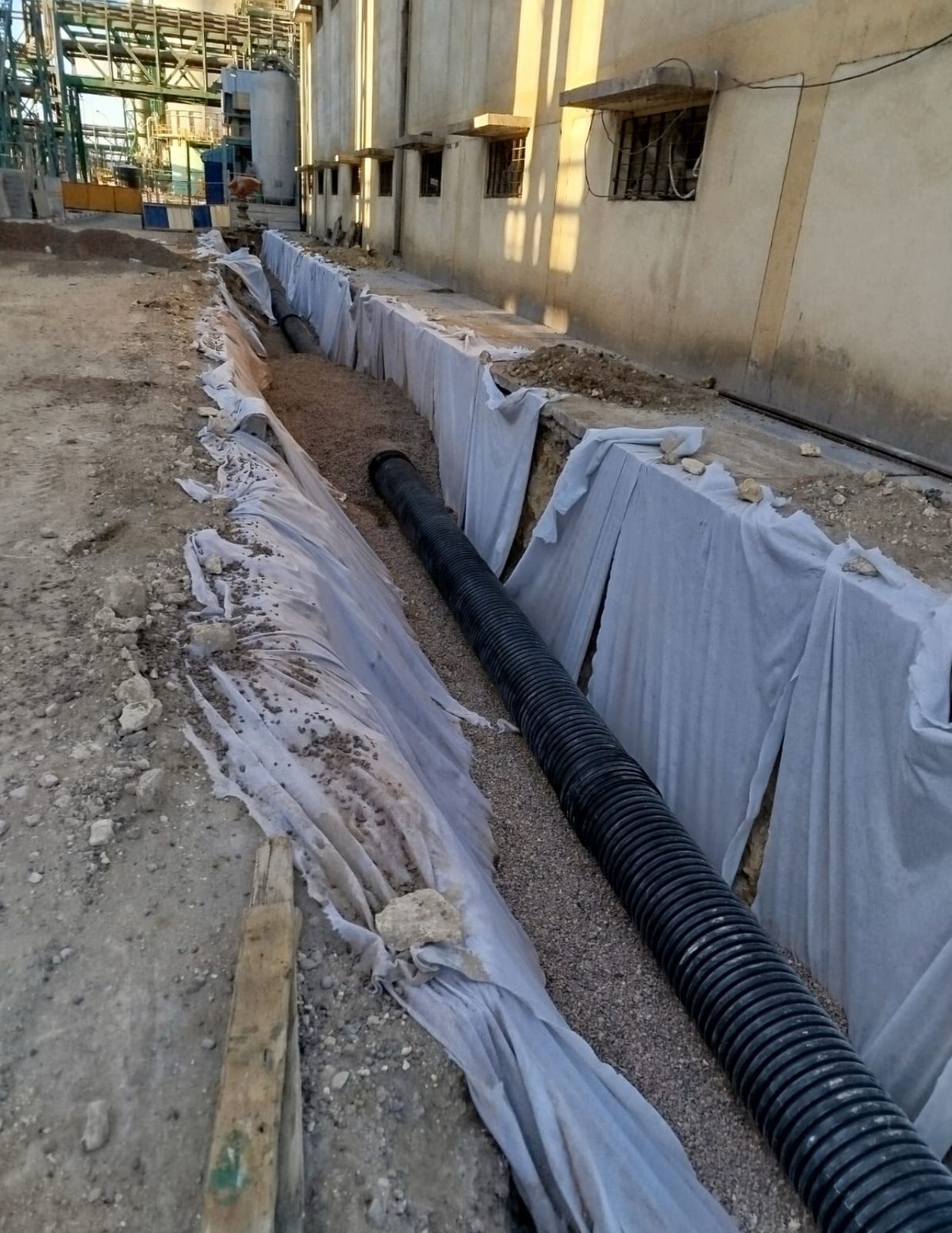 Drainage pipe installation with protective fabric